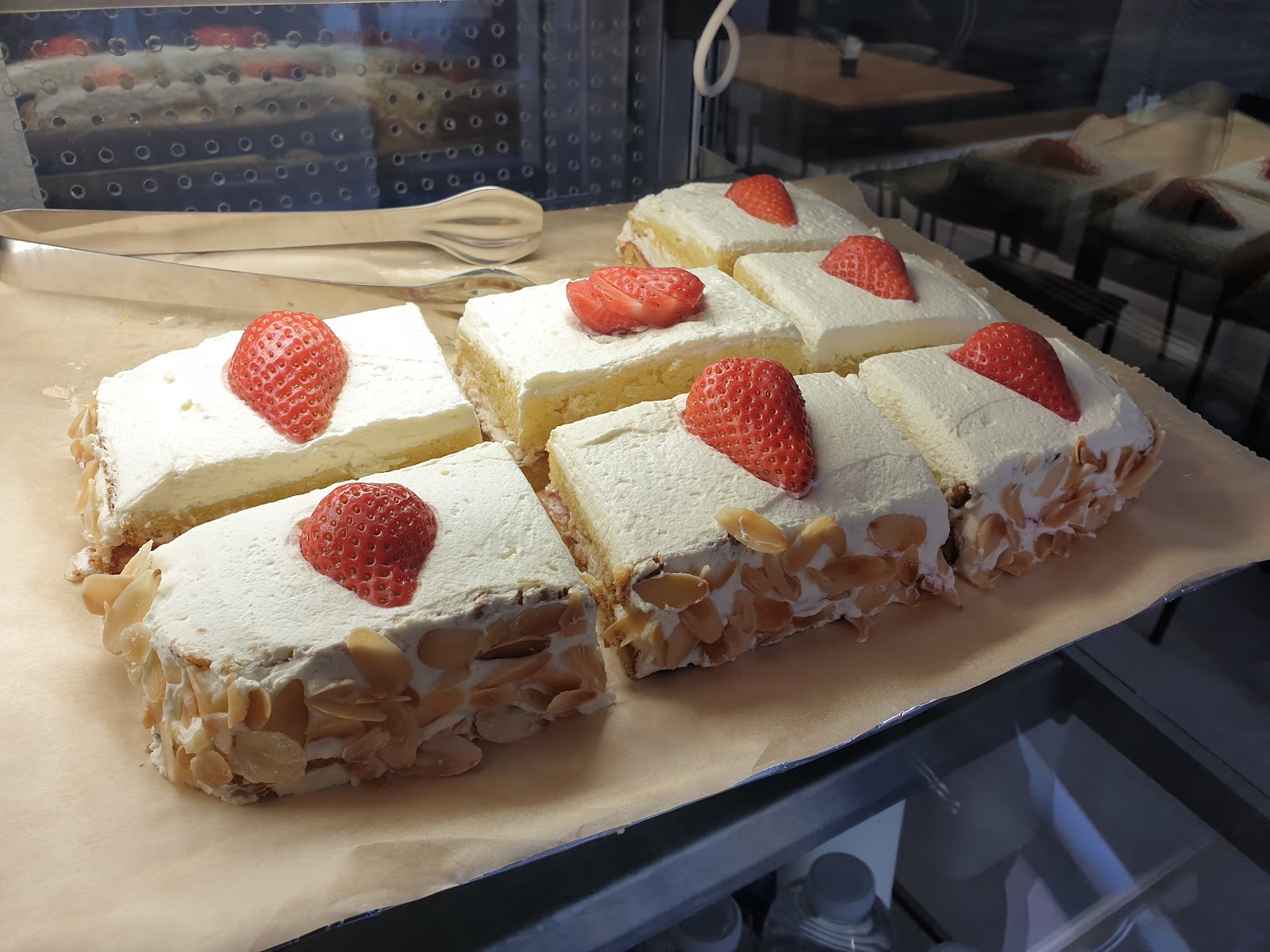Homemade strawberry cream cakes in the display case